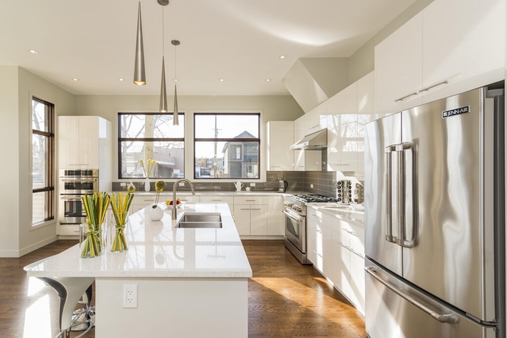 Bright and modern kitchen renovation in Palmers Green with stainless steel appliances and white cabinetry.