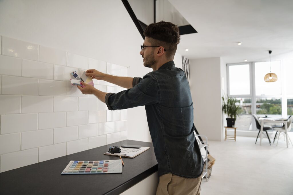 A man choosing color for new tiles for his kitchen renovation
